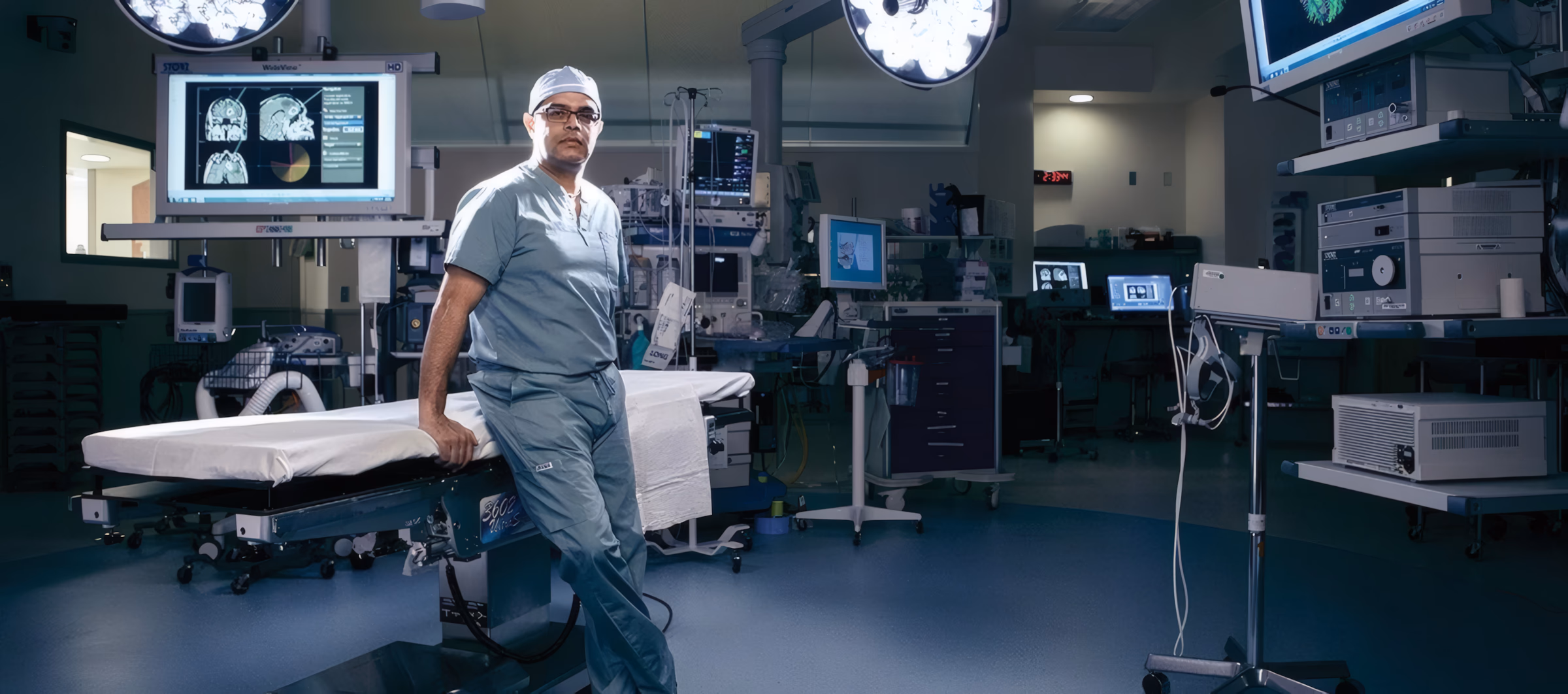 Amin B. Kassam, MD in the operating room with neurosurgical imaging equipment